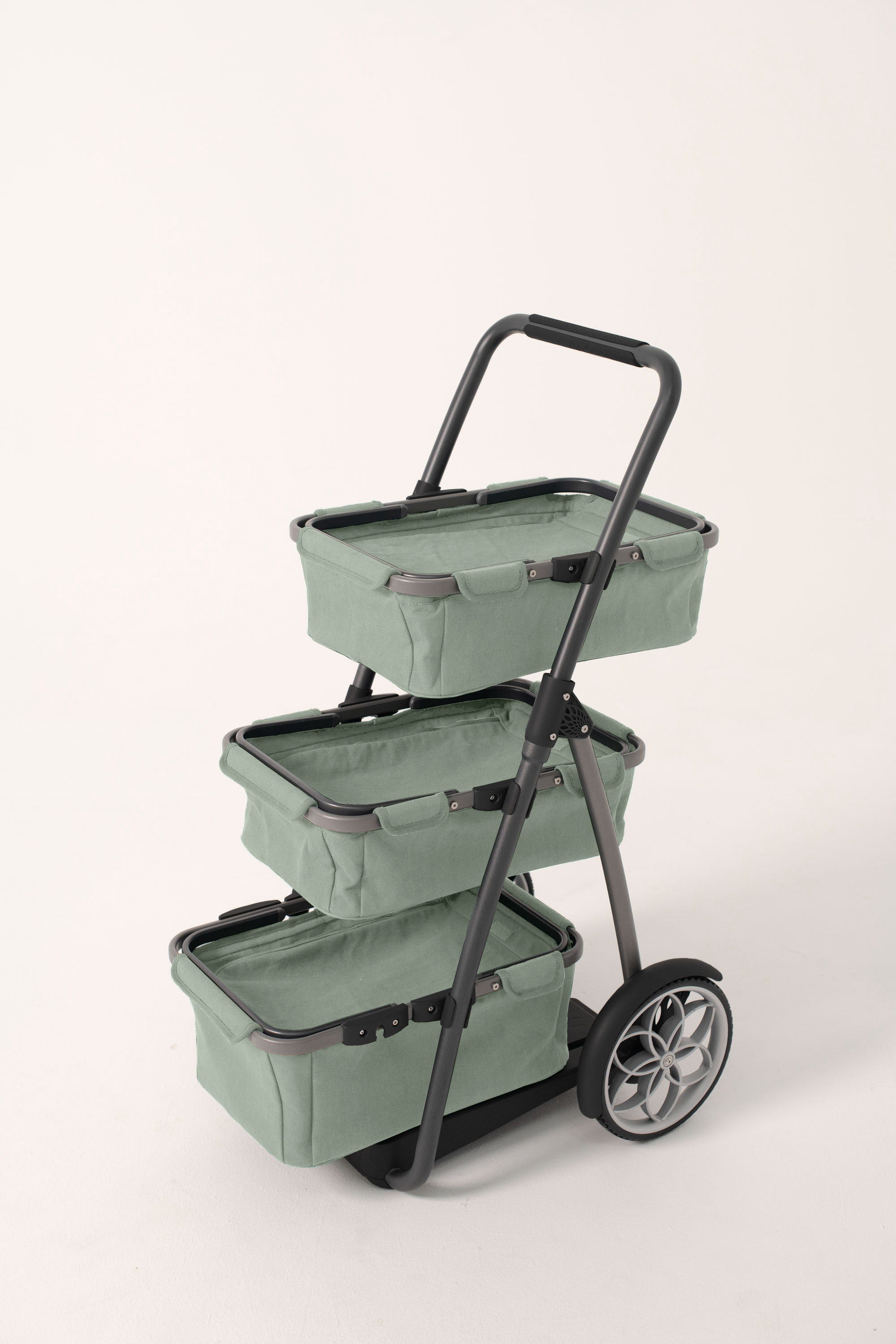 Three-tiered green shopping cart with wheels on a white background